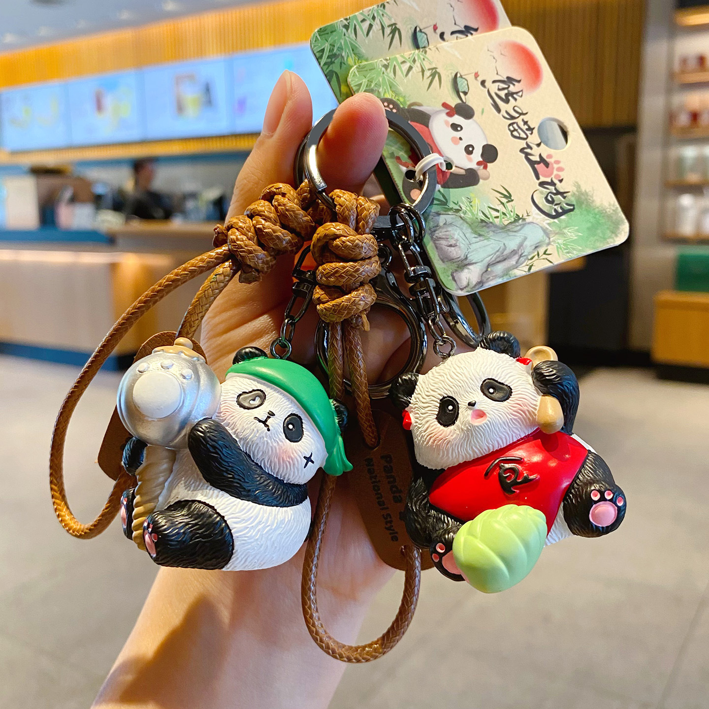 Clumsy panda and sweet panda girl keychain charms