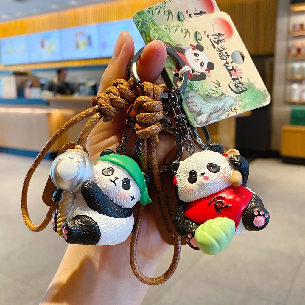 Clumsy panda and sweet panda girl keychain charms