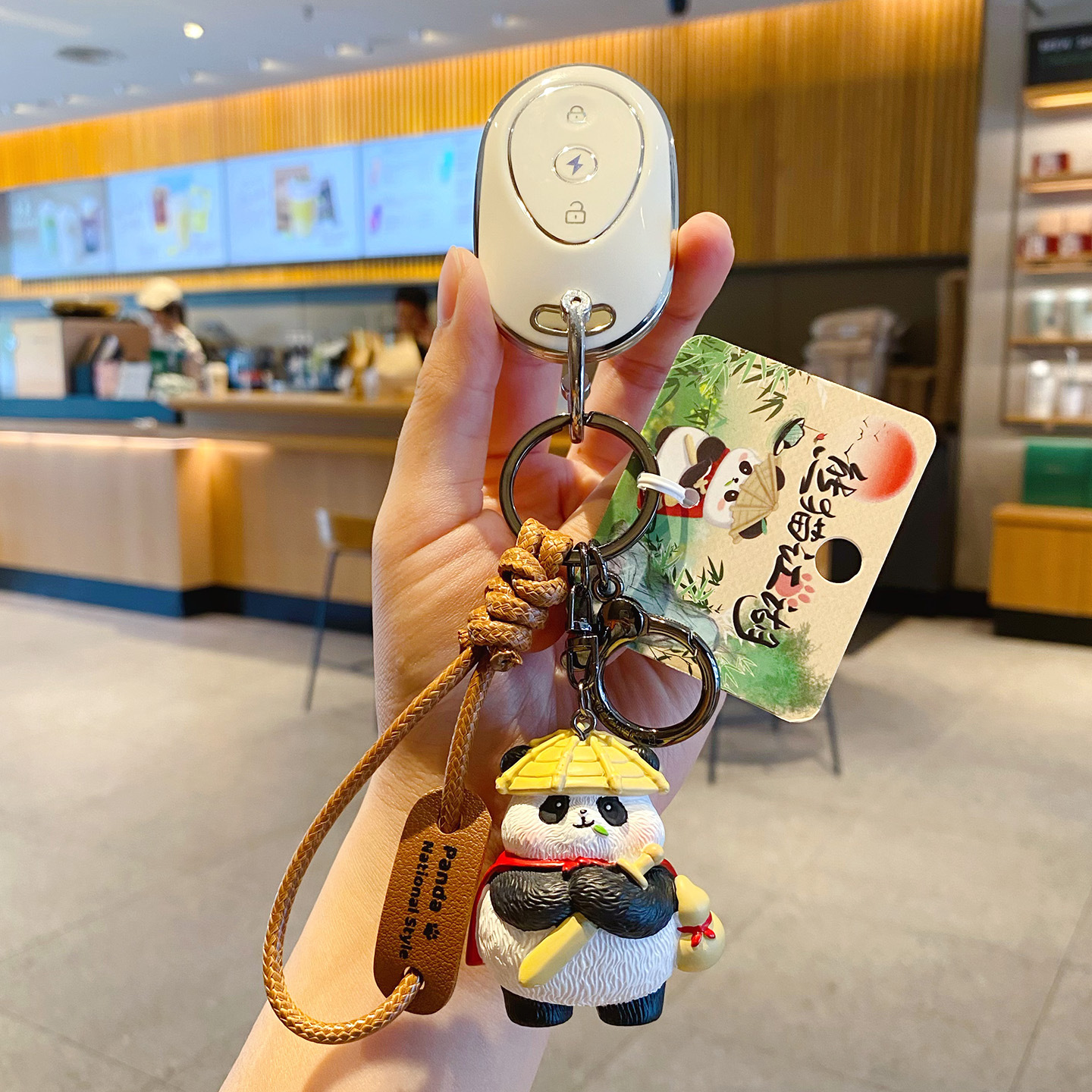 Panda hero keychain charm attached to a car key fob