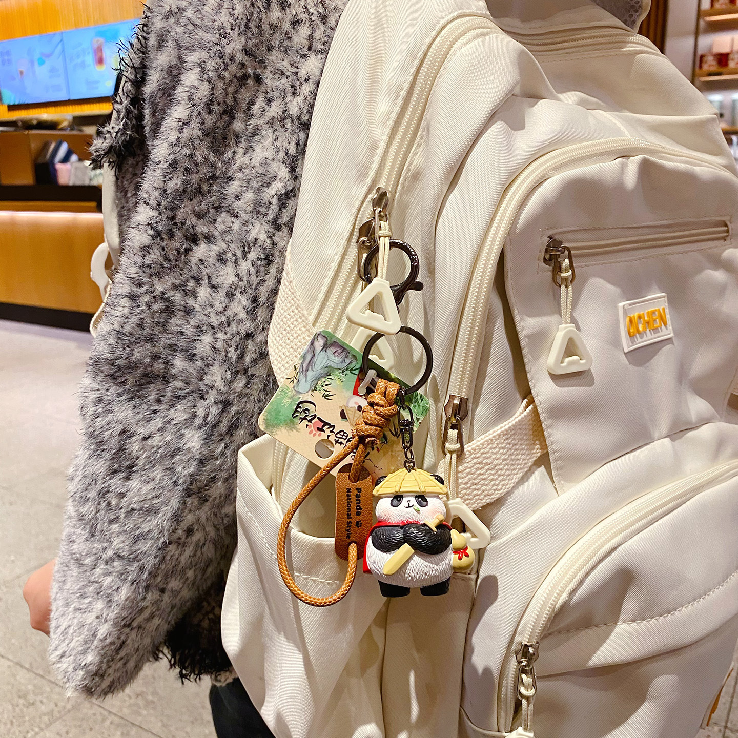 Panda hero keychain charm hanging on a bag