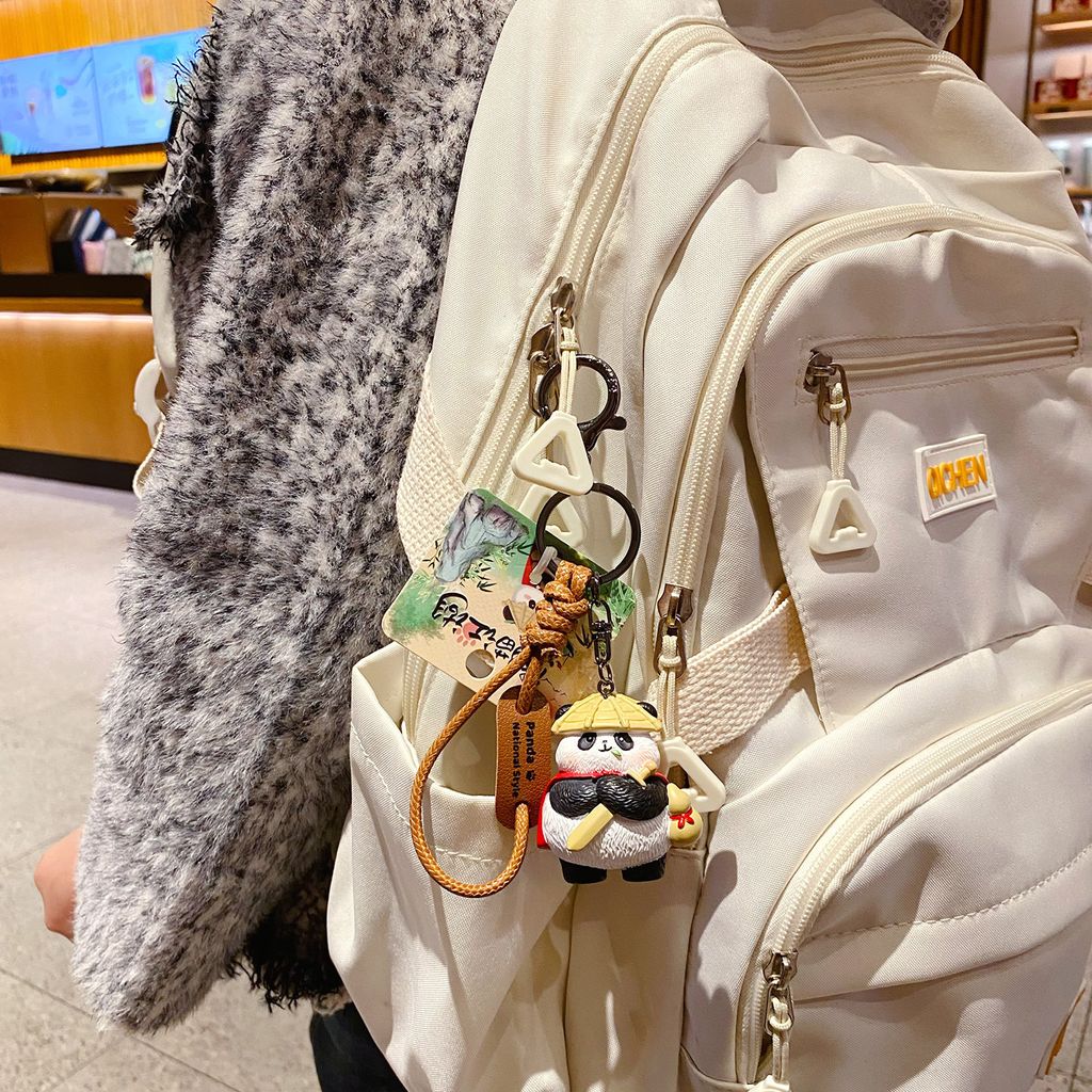 Panda hero keychain charm hanging on a bag