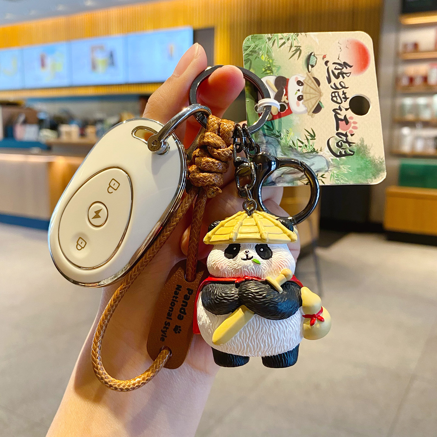 Panda hero keychain charm attached to a car key fob