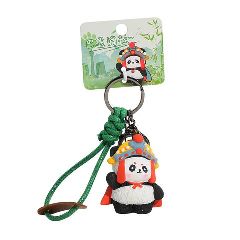 Face-changing panda keychain charm on white background