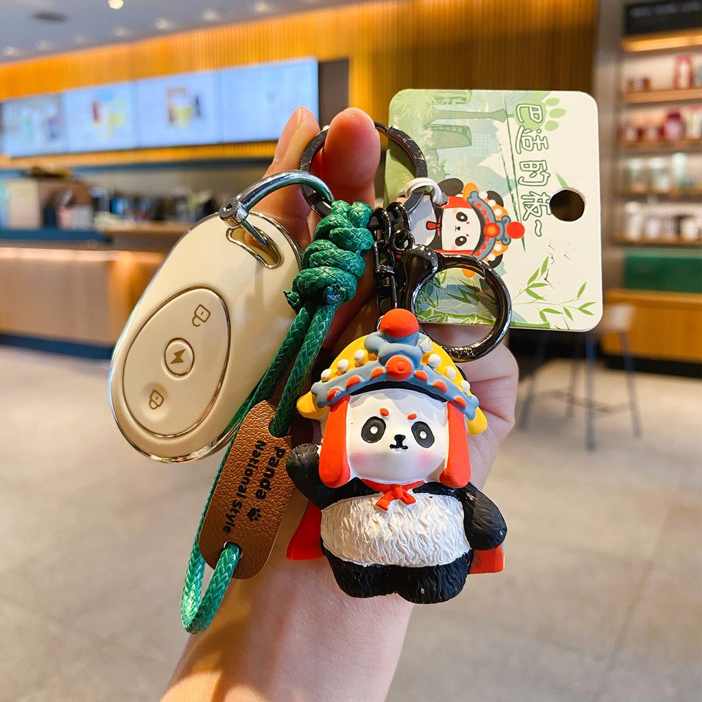 Face-changing panda keychain charm attached to a car key fob