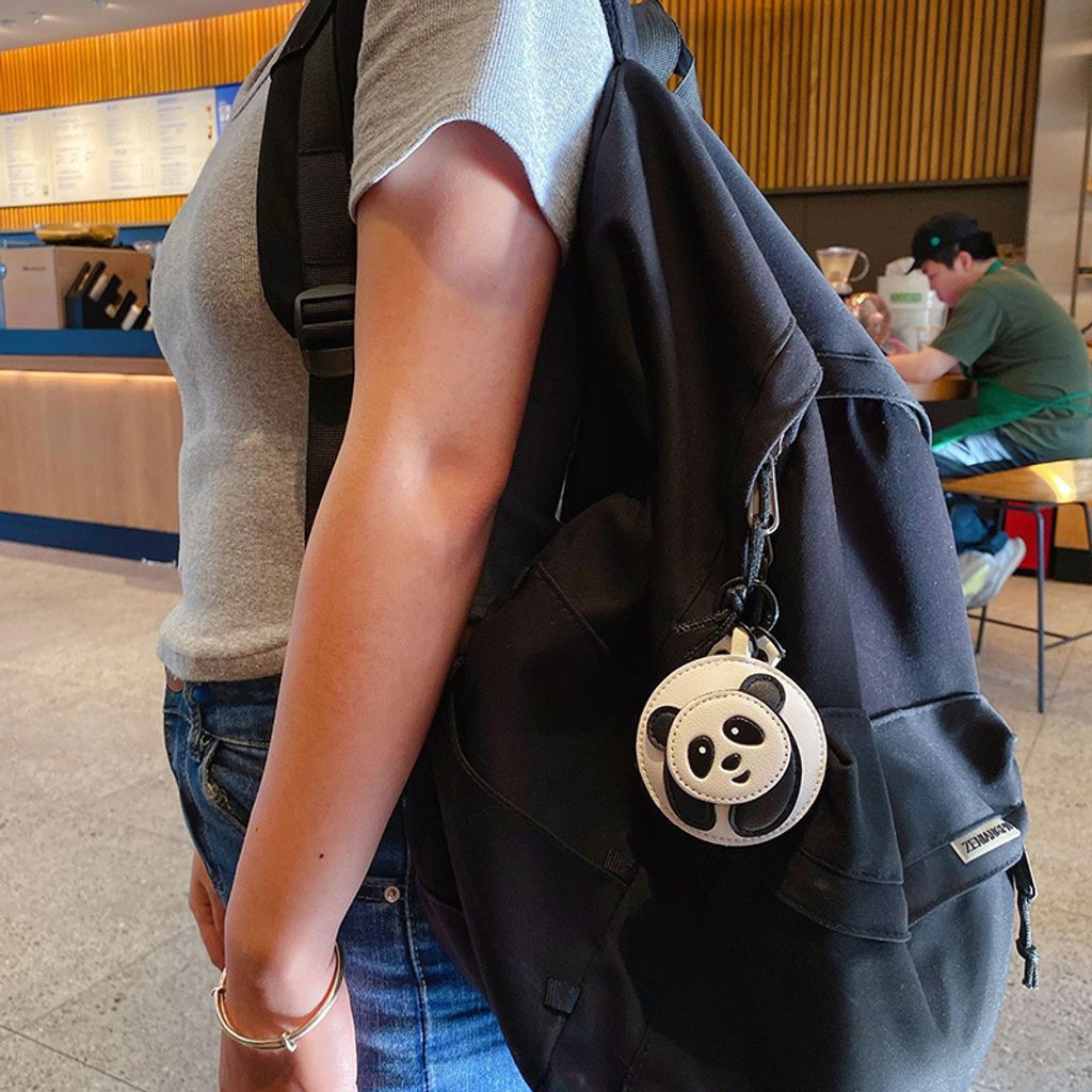 Panda keychain charm hanging on a bag