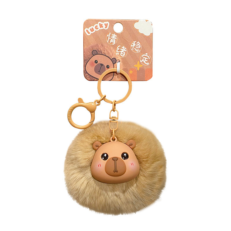 Capybara pom pom keychain charm on white background