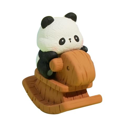Panda cub mini figurine on white background