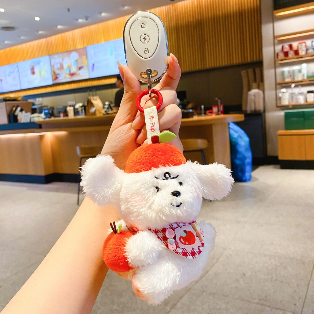 Apple puppy keychain charm attached to a car key fob