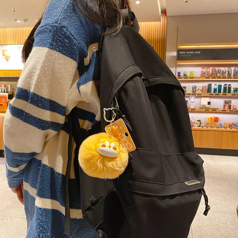 Golden British Shorthair Cat pom pom keychain charm hanging on a bag
