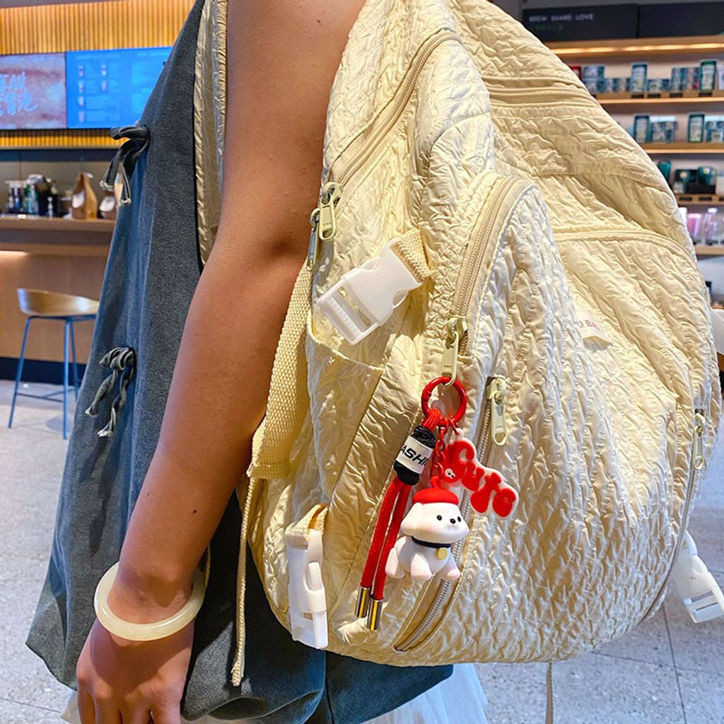 Fun fun puppy keychain charm in red, shown hanging on a bag