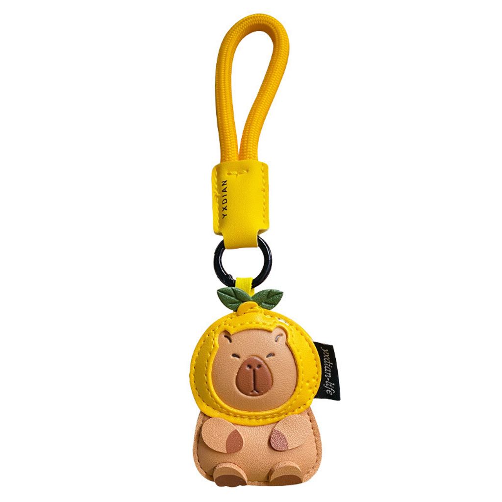 Cute leather capybara keychain charm on white background