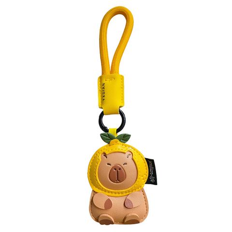 Cute leather capybara keychain charm on white background