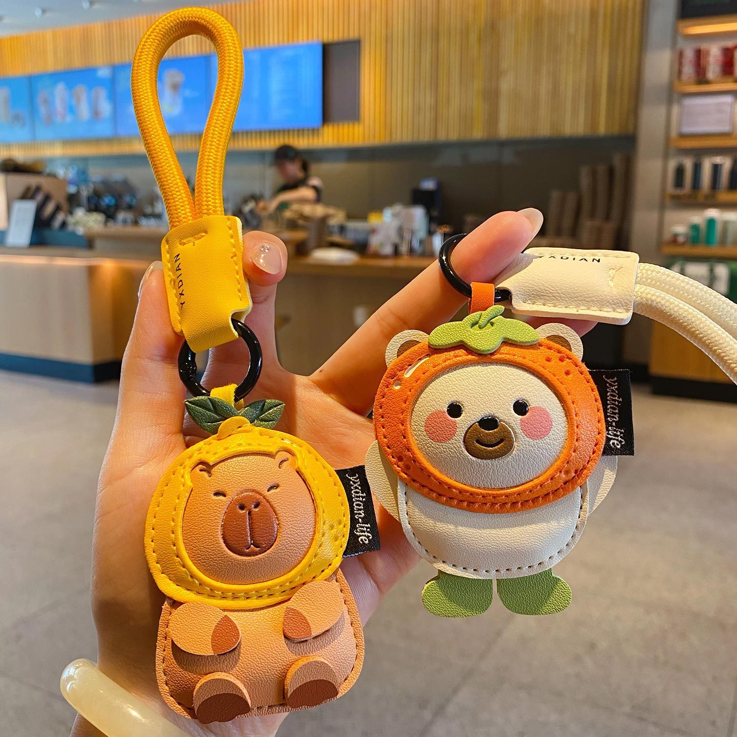 Cute leather animal keychain charms featuring a capybara and a polar bear