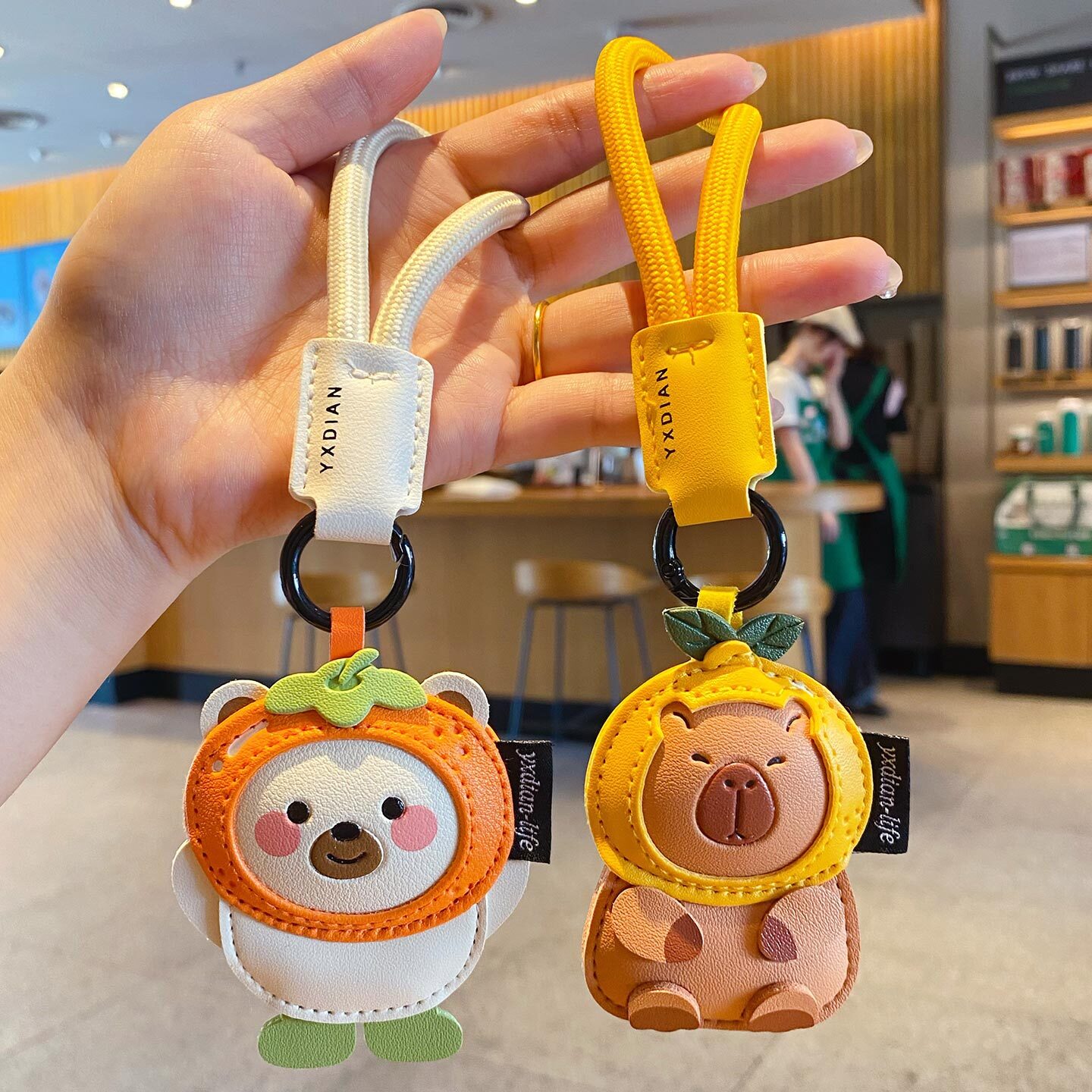 Cute leather animal keychain charms featuring a polar bear and a capybara