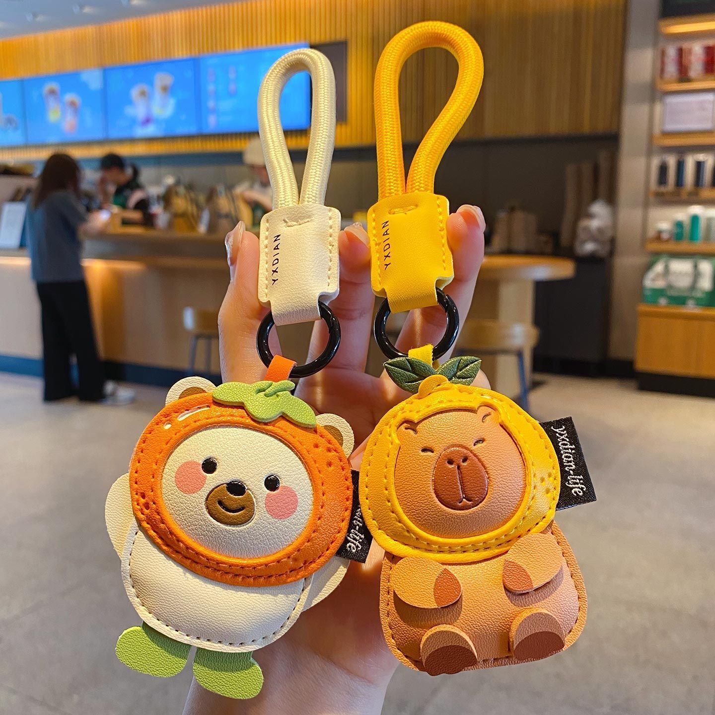 Cute leather animal keychain charms featuring a polar bear and a capybara