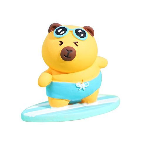 Surfer capybara mini figurine on white background
