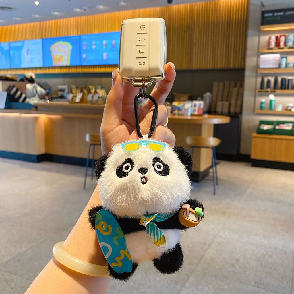 Panda plush skateboard keychain charm attached to a car key fob