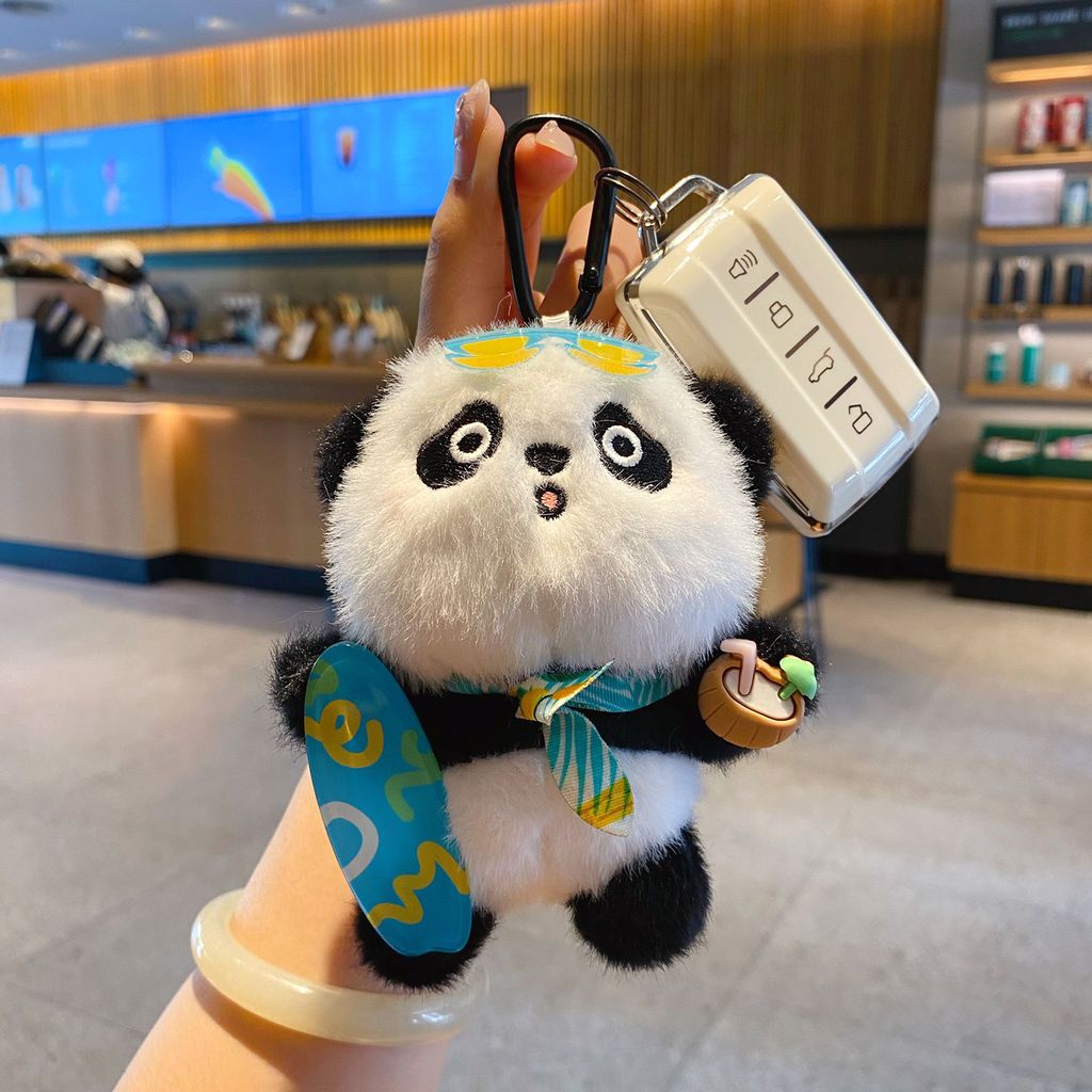 Panda plush skateboard keychain charm attached to a car key fob