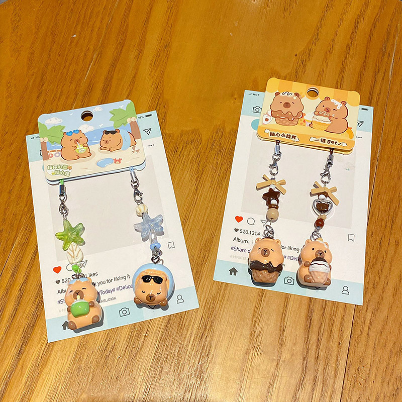 Beach capybara and dessert capybara beaded keychain charm pairs