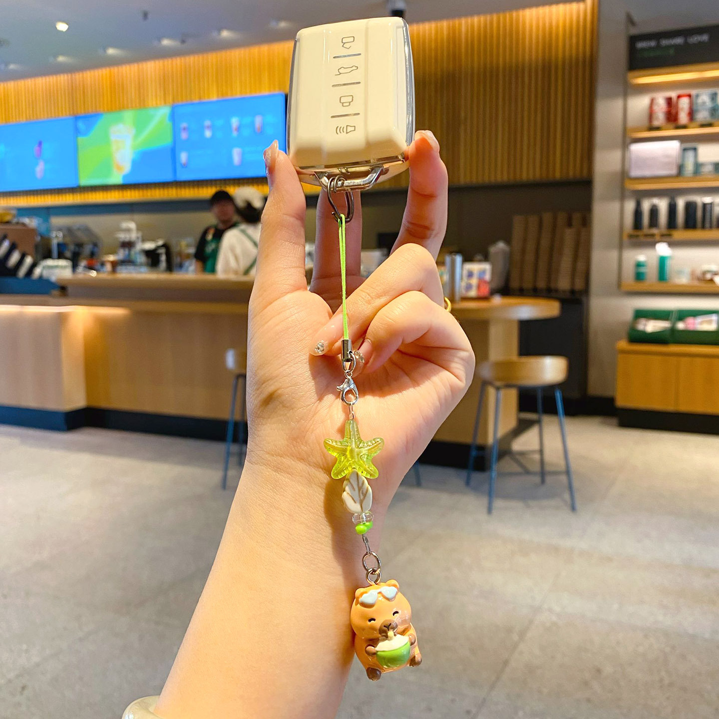 Beach capybara beaded keychain charm attached to a car key fob