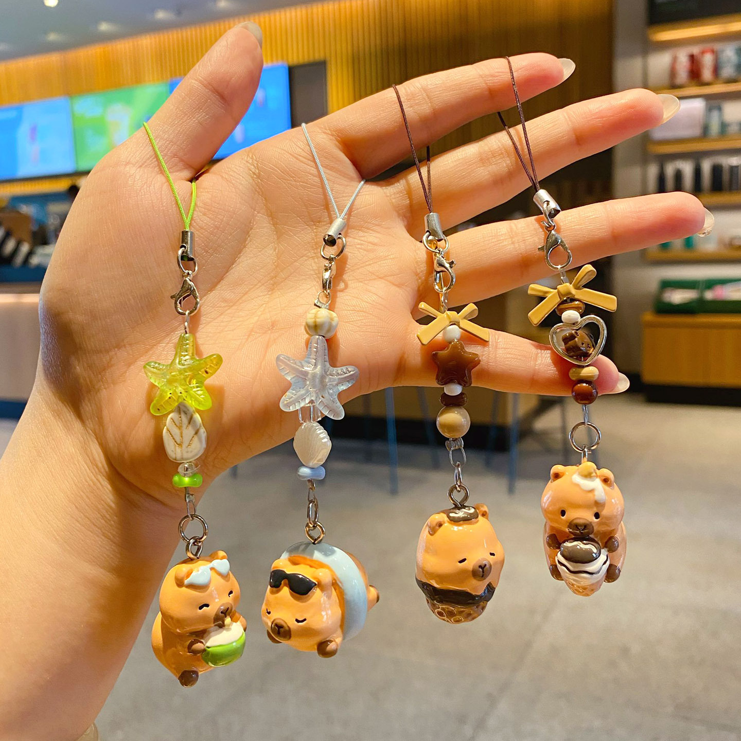 Beach capybara and dessert capybara beaded keychain charm pairs