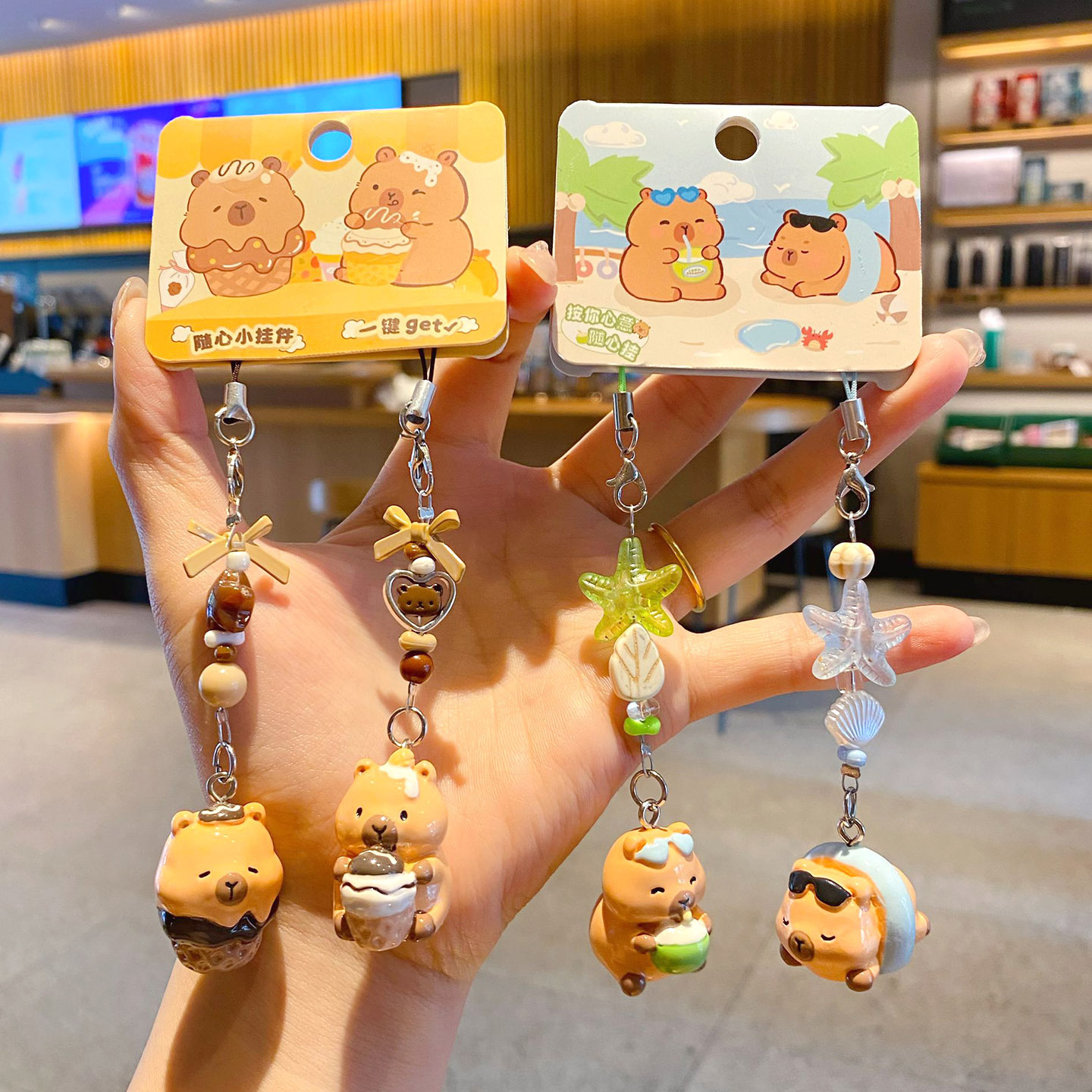 Beach capybara and dessert capybara beaded keychain charm pairs