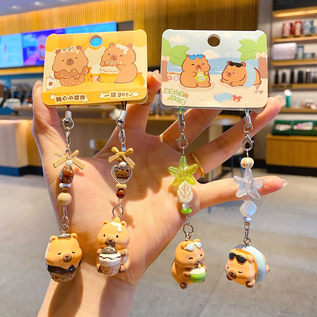 Beach capybara and dessert capybara beaded keychain charm pairs