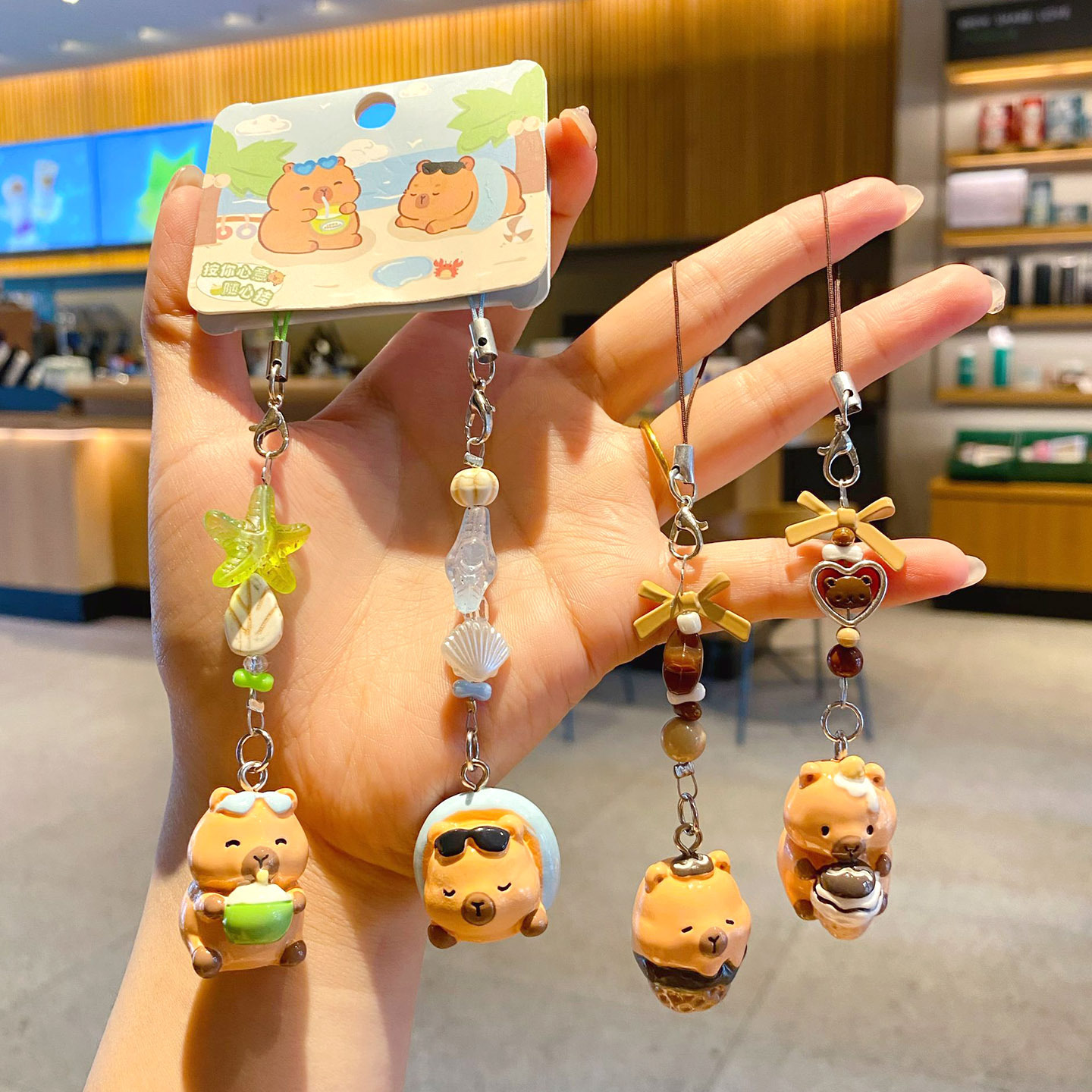 Beach capybara and dessert capybara beaded keychain charm pairs