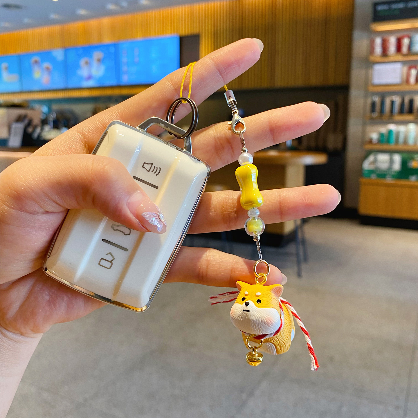 Shiba Inu puppy keychain charm attached to a car key fob