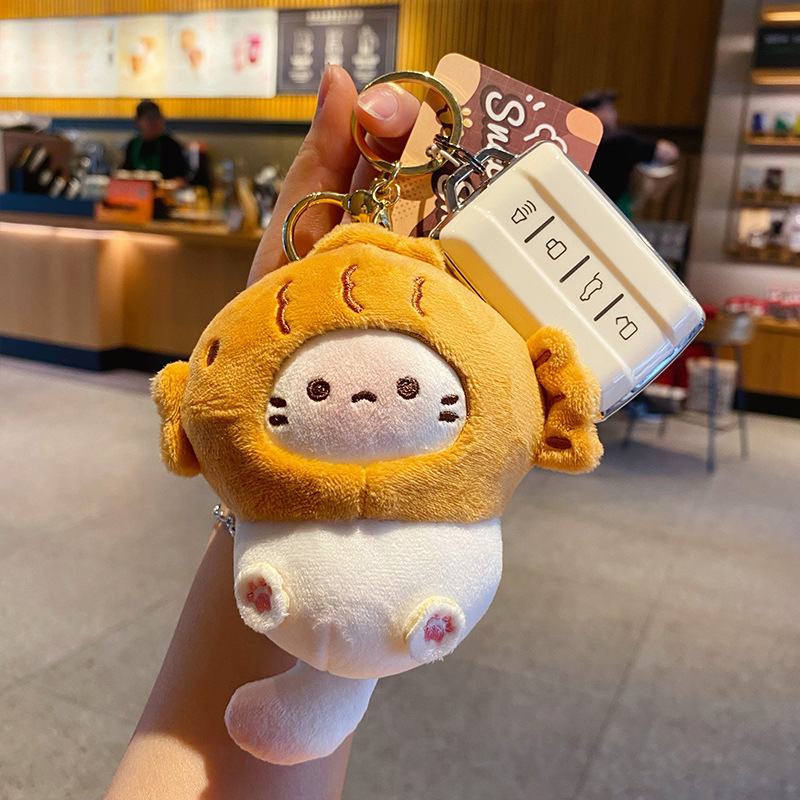 Taiyaki coco cat plush keychain charm attached to a car key fob