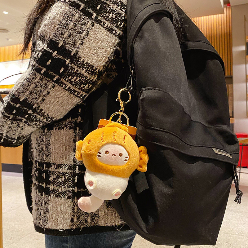Taiyaki coco cat plush keychain charm hanging on a bag