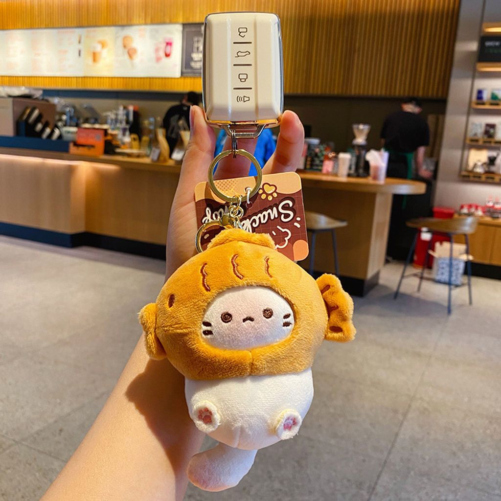 Taiyaki coco cat plush keychain charm attached to a car key fob