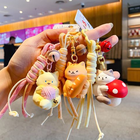 Cute hugging cat keychain charms showing multiple designs