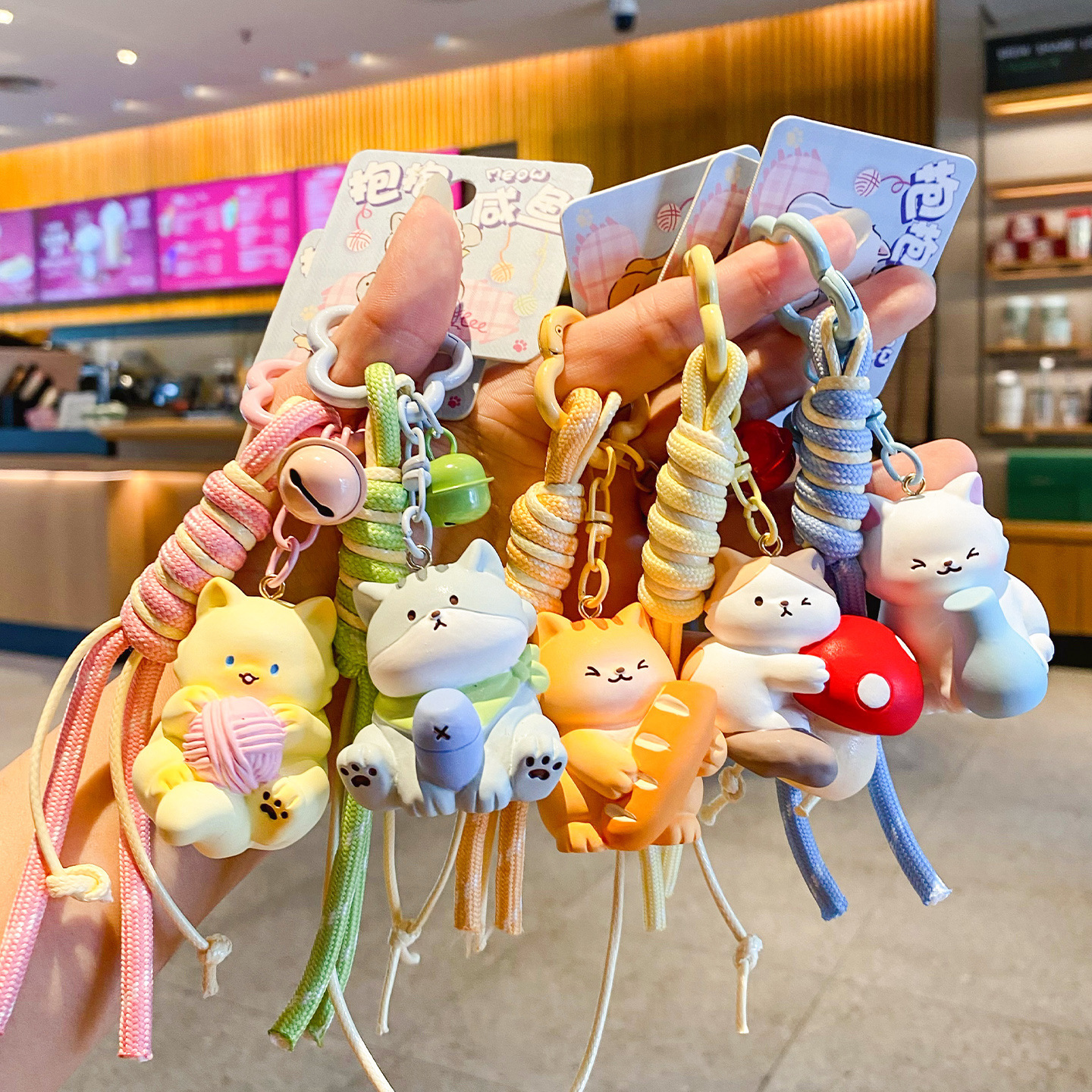 Cute hugging cat keychain charms showing multiple designs