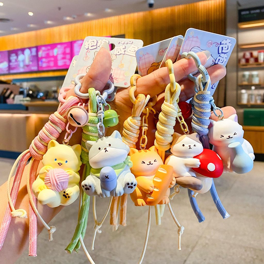 Cute hugging cat keychain charms showing multiple designs