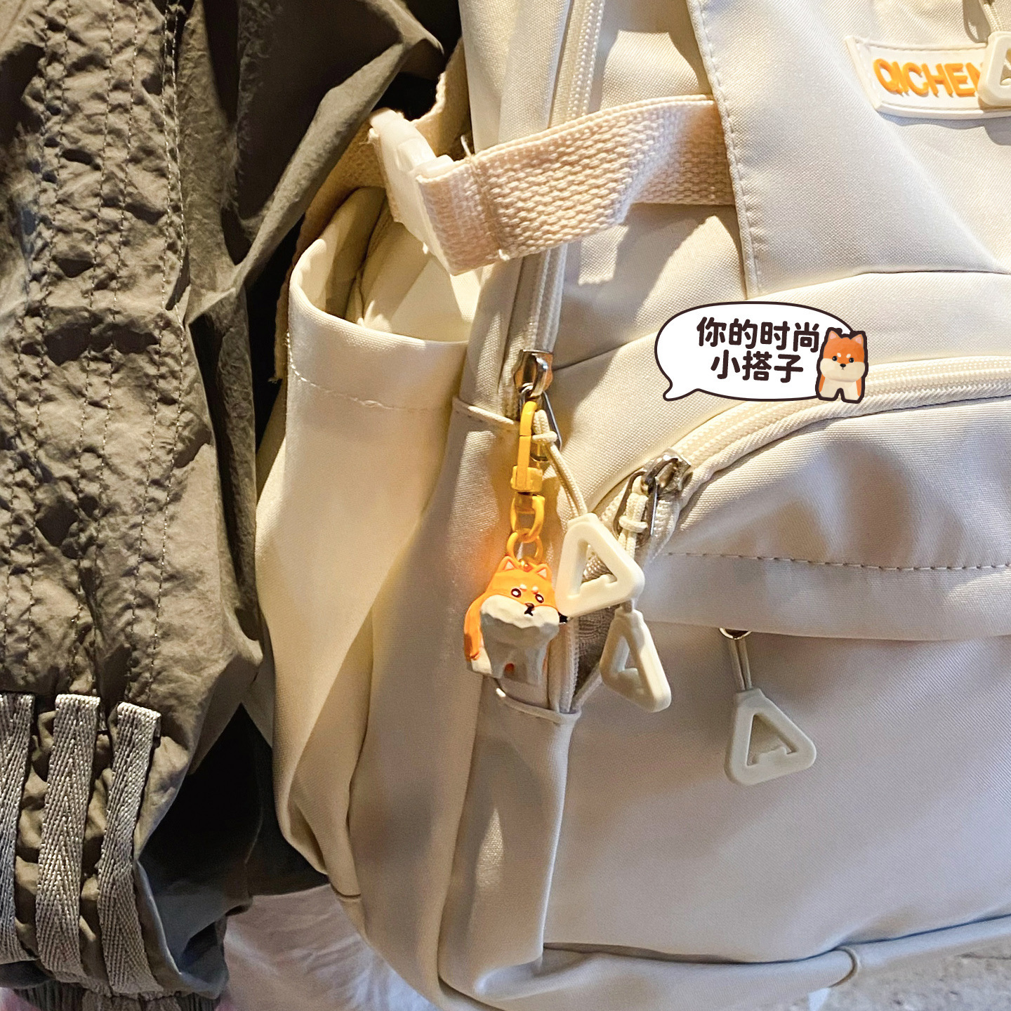 Adorkable puppy keychain charm hanging on a bag