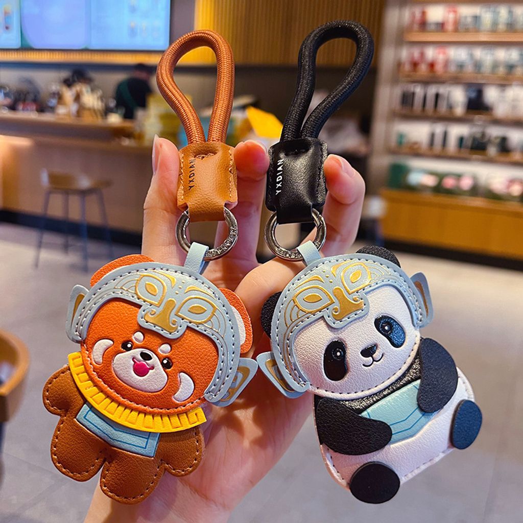 Red panda and panda leather keychain charms with Sanxingdui mask design