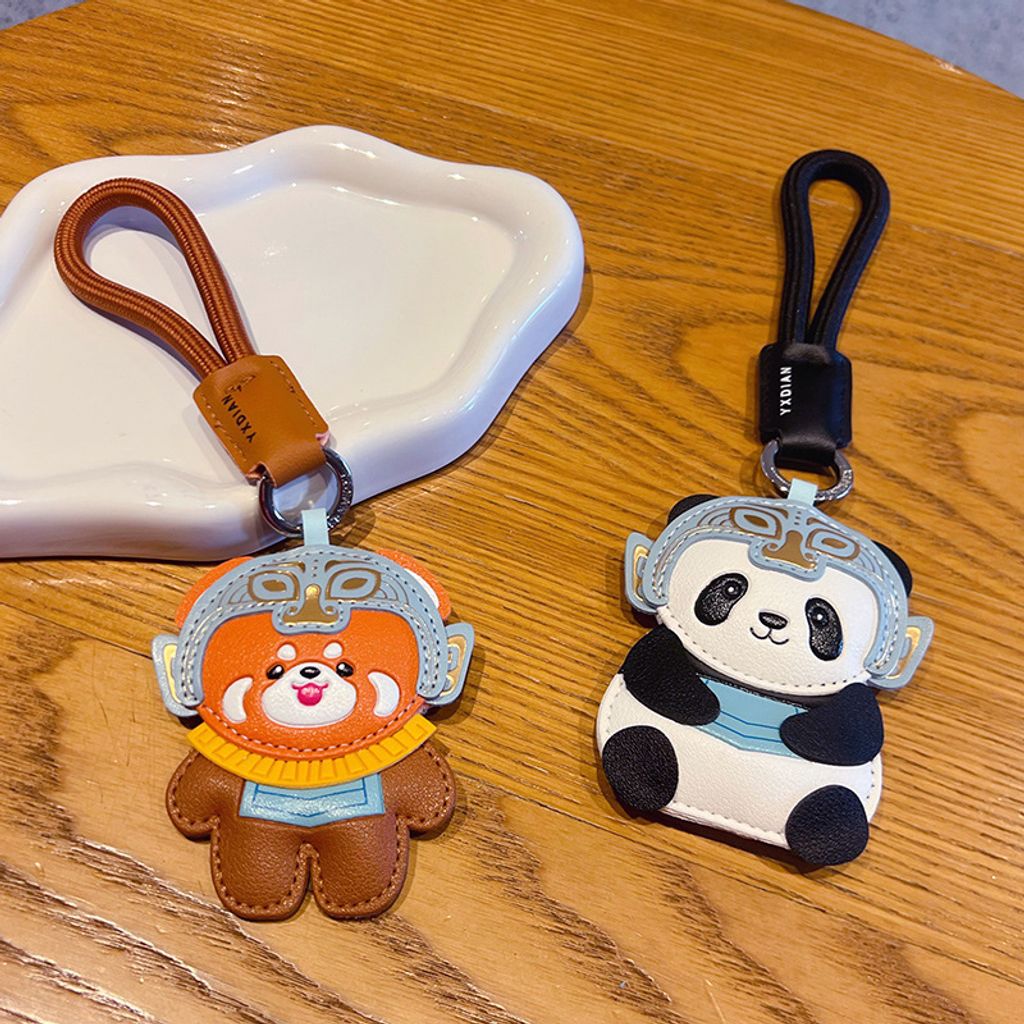 Red panda and panda leather keychain charms with Sanxingdui mask design