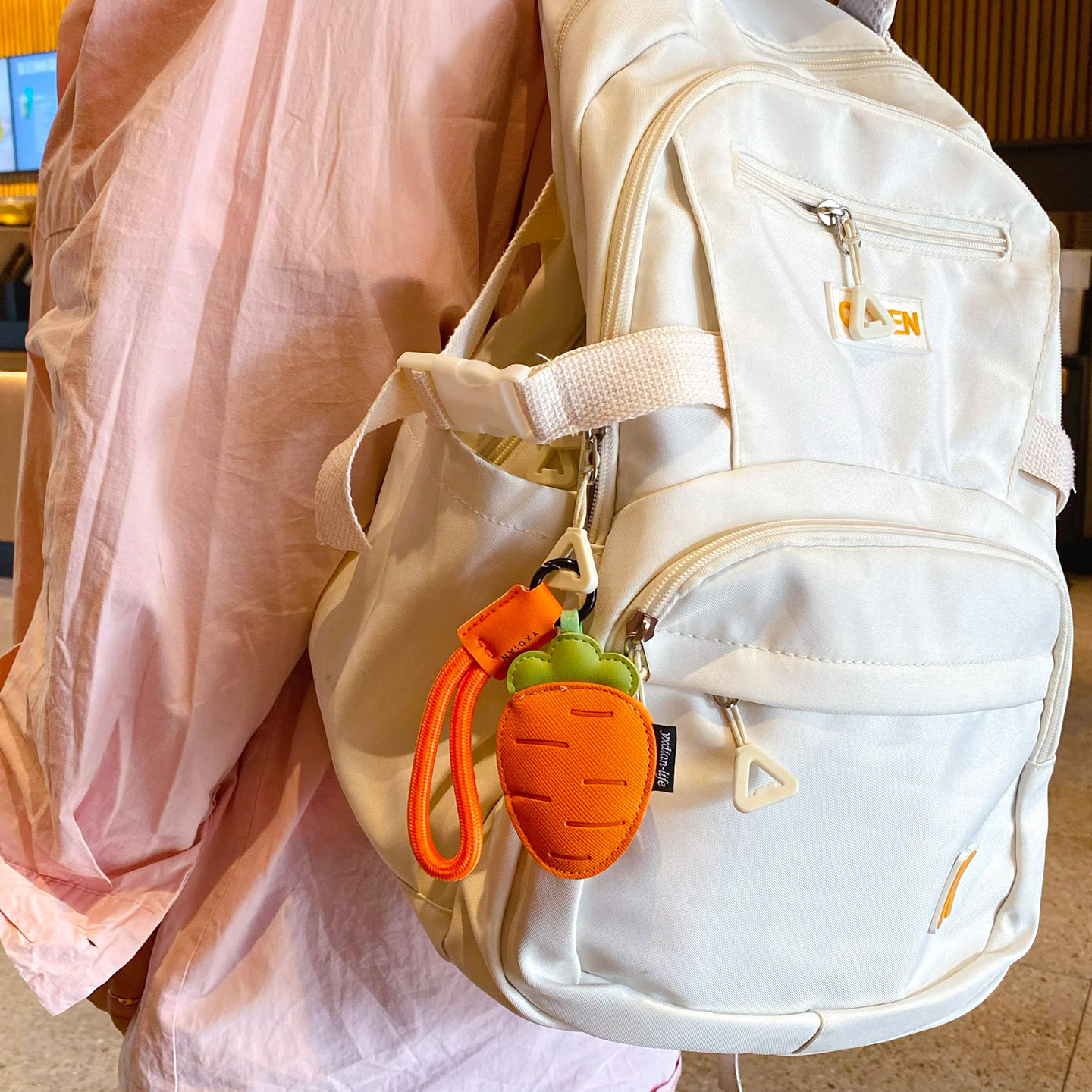 Carrot vegetable leather keychain charm hanging on a bag