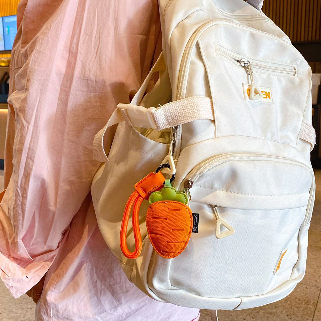 Carrot vegetable leather keychain charm hanging on a bag