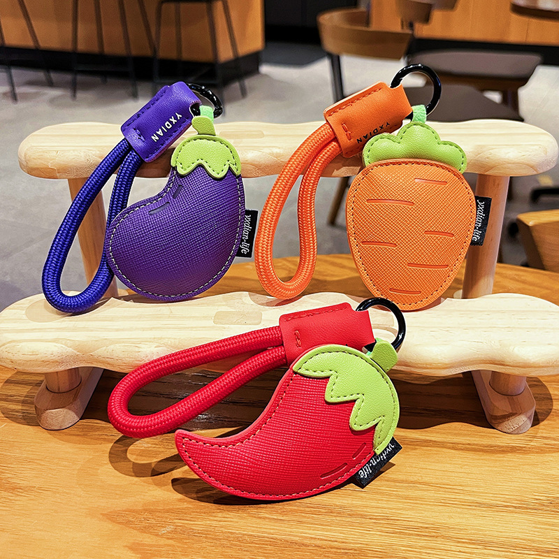 Carrot, chili pepper, and eggplant vegetable leather keychain charms featuring all three designs