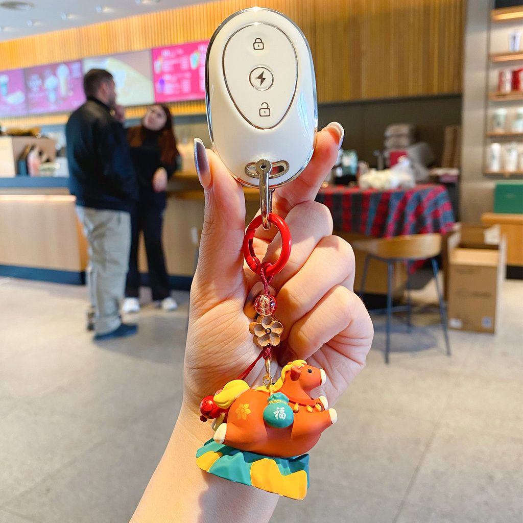 Tang-style cute smooth-sailing pony keychain charm attached to a car key fob