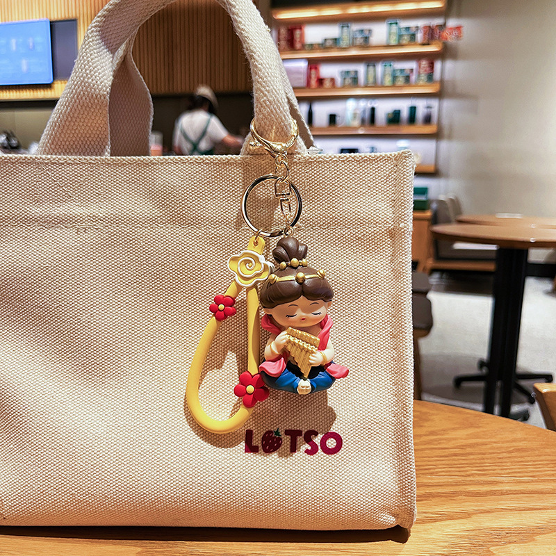 Dunhuang Flying Apsara keychain charm in pan flute style hanging on a bag