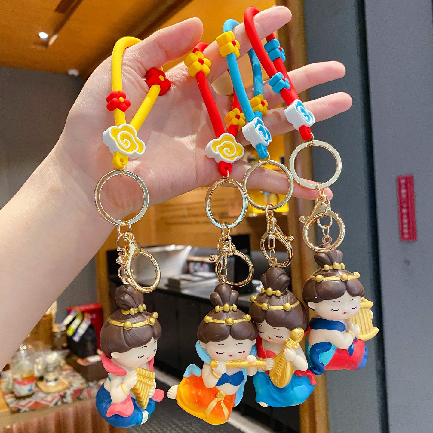 Dunhuang Flying Apsara keychain charms featuring all four designs