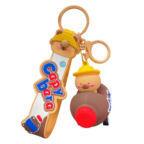 Cute capybara in a brown cola bottle car keychain charm on white background