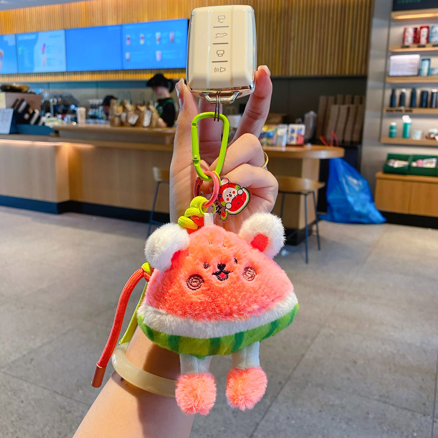Cute watermelon rabbit plush keychain charm attached to a car key fob