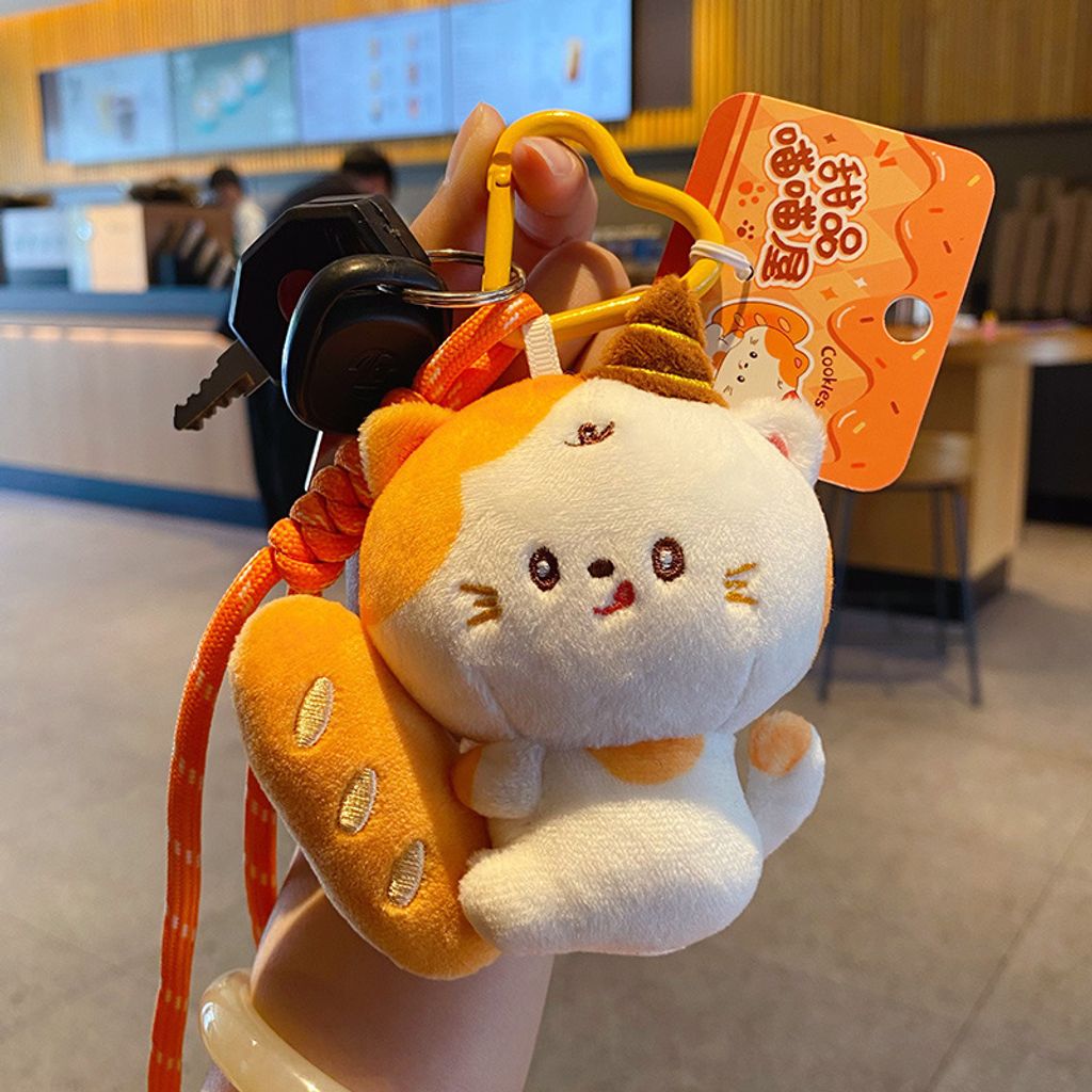 Baguette cat plush keychain charm attached to car keys