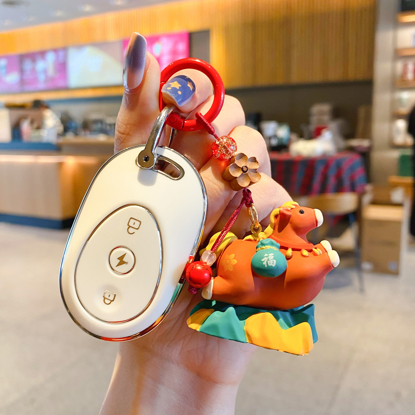 Tang-style cute smooth-sailing pony keychain charm attached to a car key fob