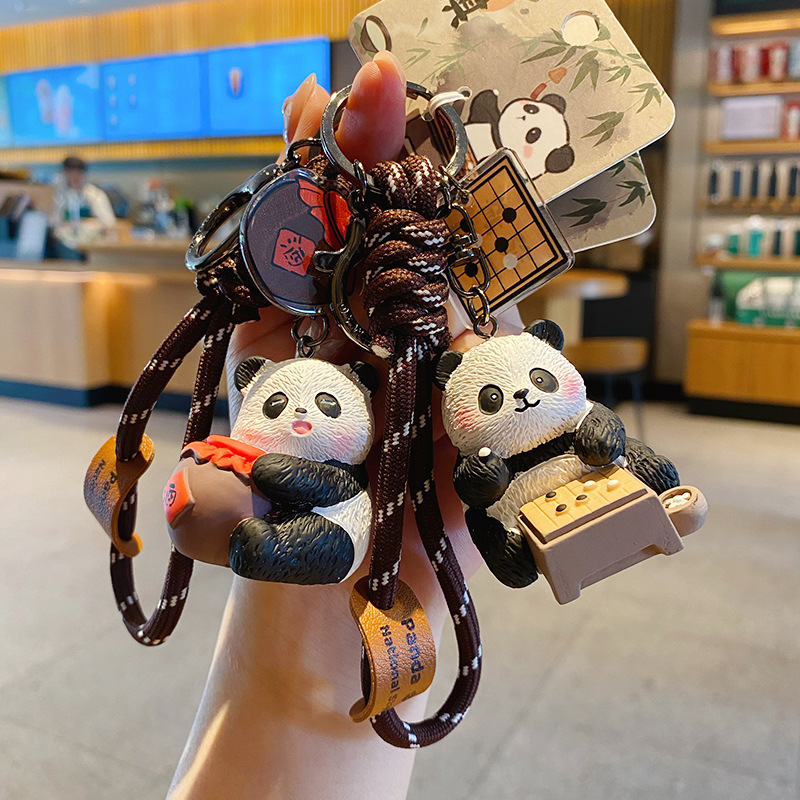 Wine-drinking panda and Go-playing panda keychain charms with traditional refined arts designs