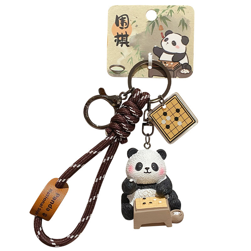 Go-playing panda keychain charm with traditional refined arts design on white background